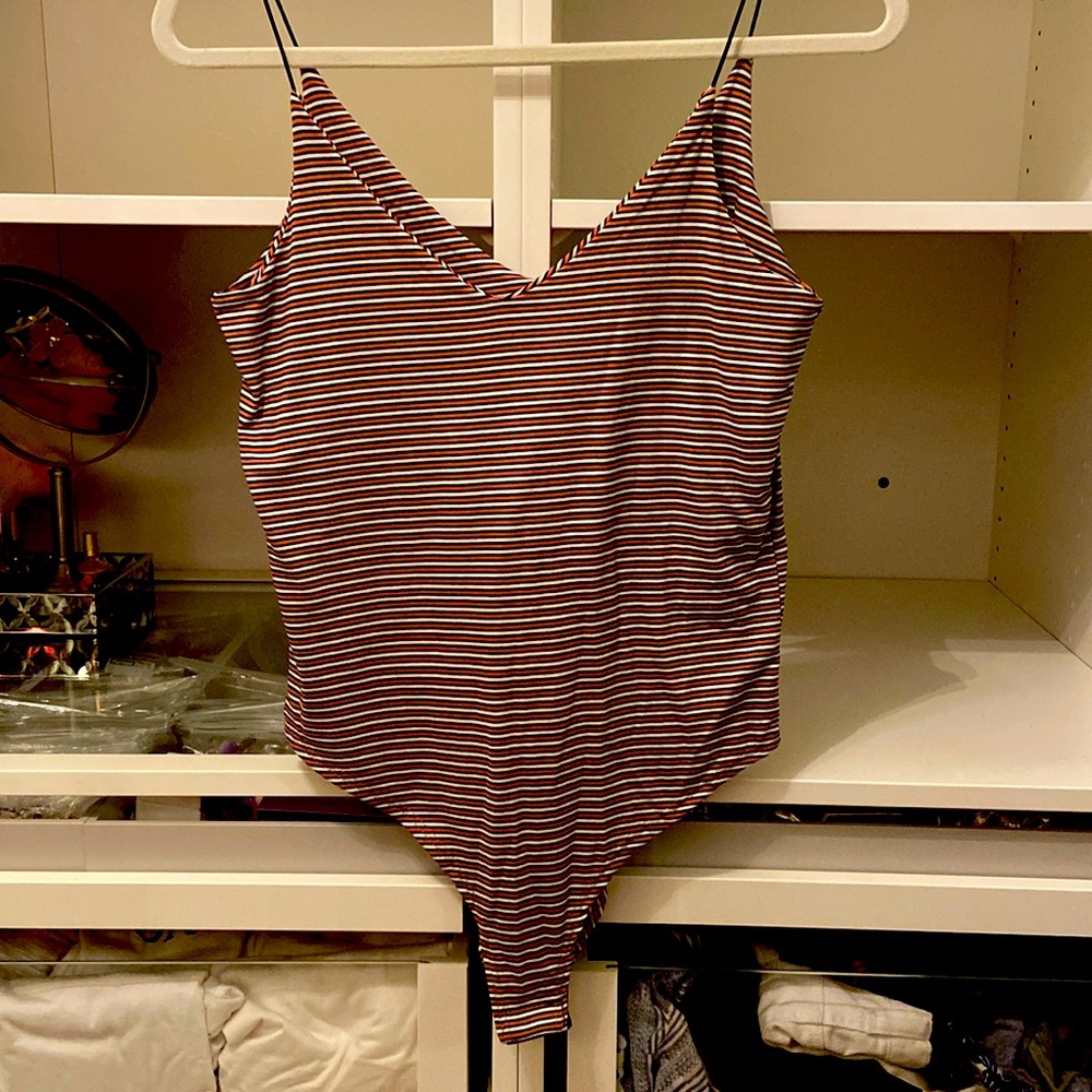 Burnt orange, cream and black, double V-neck bodysuit with a snap closure